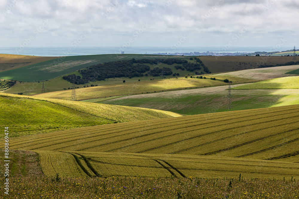 A view over farmland in the South Downs looking towards the coast near Brighton A view over farmland in the South Downs looking towards the coast near Brighton