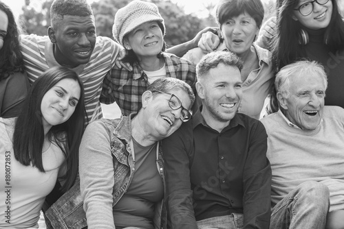 Fotografija Crowd of multiracial people having fun hugging each others at city park - Social