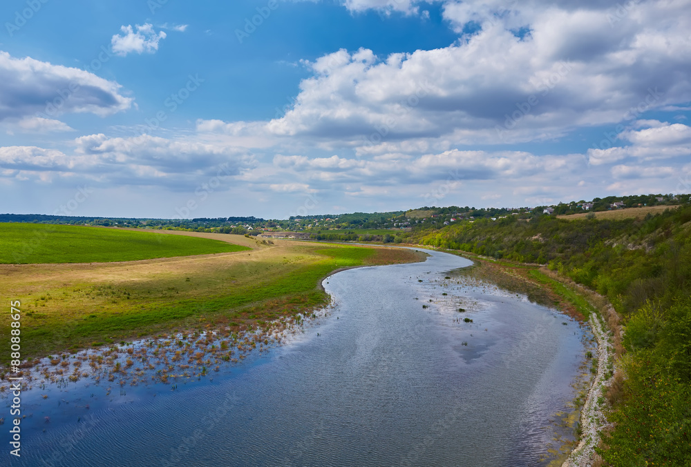 Beautiful landscape. Wide river, blue sky with white clouds. Beautiful landscape. Wide river, blue sky with white clouds.