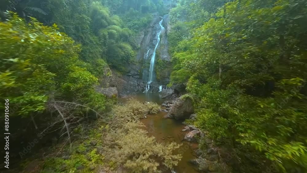 Embark on an adventure to discover a serene jungle waterfall surrounded by lush greenery and rocks Embark on an adventure to discover a serene jungle waterfall surrounded by lush greenery and rocks