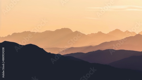 Silhouette of mountains during sunset with a gradient of warm colors and layered peaks.