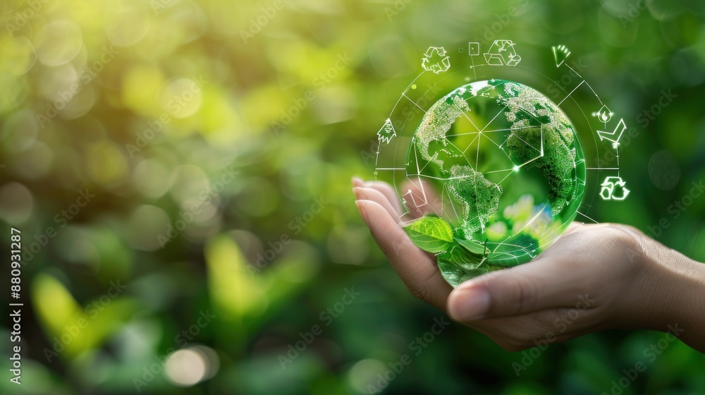 A hand holding a globe and recycling icon on a green background A hand holding a globe and recycling icon on a green background