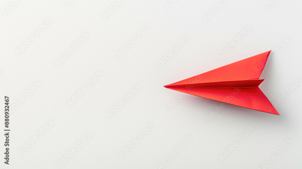 A red paper airplane is on a white background A red paper airplane is on a white background