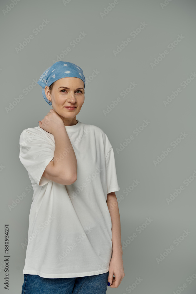A woman wearing a blue bandana and a white shirt looks directly at the camera with a confident smile. A woman wearing a blue bandana and a white shirt looks directly at the camera with a confident smile.
