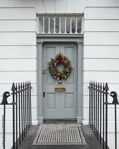 Victorian Door in London, England with a Traditional Christmas Wreath and Railings.