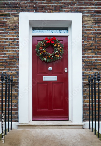 Victorian Door in London, England with a Traditional Christmas Wreath and Railings.