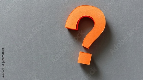 Bright orange paper question mark on grey background symbolizing search or help