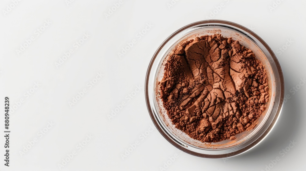 Brown foundation in glass jar top view on white background with space for text Brown foundation in glass jar top view on white background with space for text
