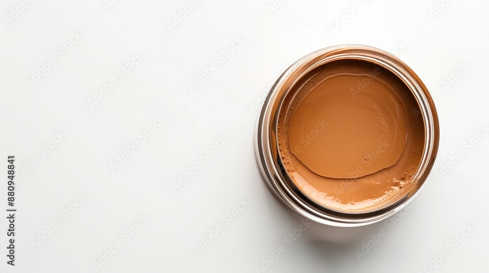 Brown foundation in glass jar top view on white background with space for text Brown foundation in glass jar top view on white background with space for text