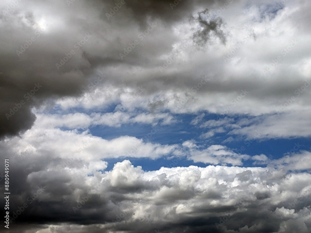 Obraz premium Moody Dark Fluffy White Clouds in a Blue Sky as A Skyscape Background