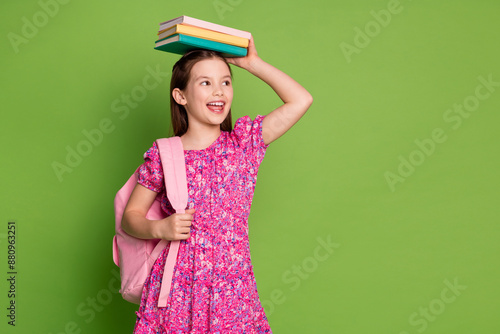 Photo of cute schoolgirl book head look empty space wear pink dress isolated on green color background