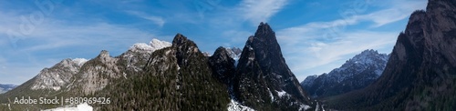 Wide panorama of Dolomites in Italy with a mountain pass and road