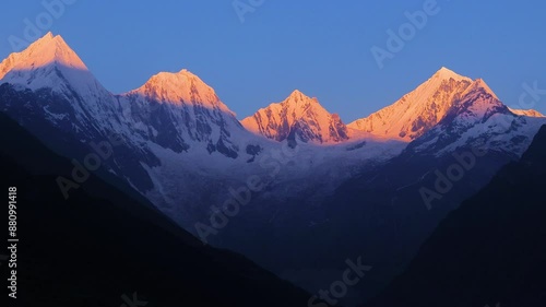 timelapse of sunrise over panchachuli peaks of himalaya. The golden sunlight on the snow peaks of the mountains. The video taken from Dantu village of darma valley uttarakhand. 