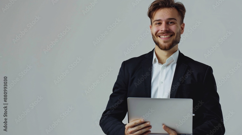 A smiling man in a stylish black suit speaks into a laptop, set against a white background A smiling man in a stylish black suit speaks into a laptop, set against a white background