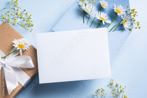 Empty blank card,  gift box and chamomile flowers photo