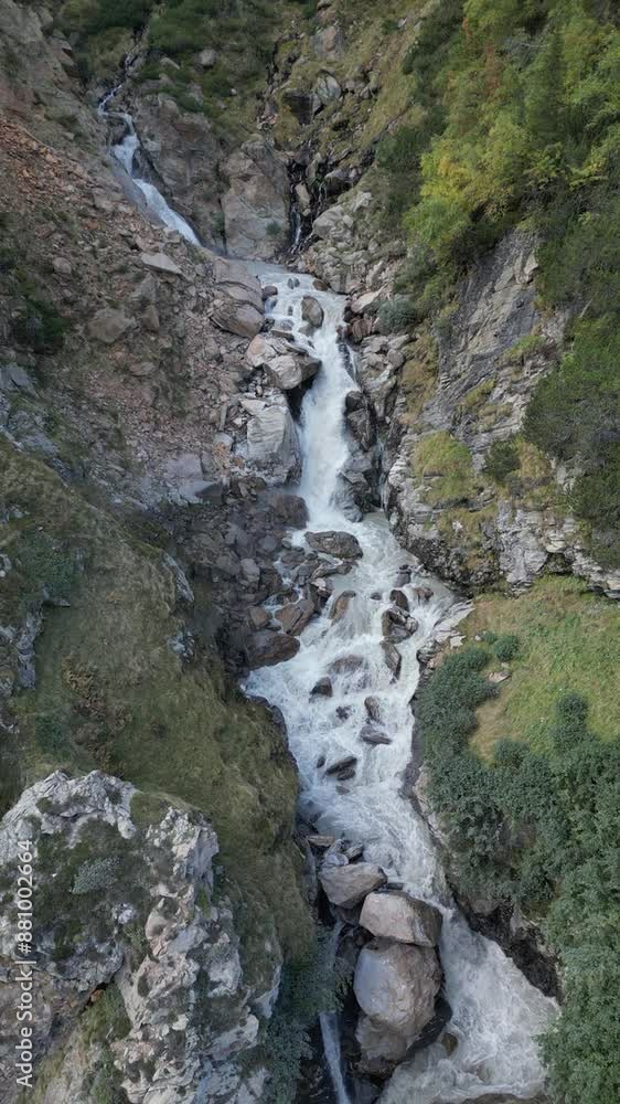 Lufaufnahme eines Wasserfalls der an einem Berg hinunterläuft und in einen kleinen See endet Lufaufnahme eines Wasserfalls der an einem Berg hinunterläuft und in einen kleinen See endet
