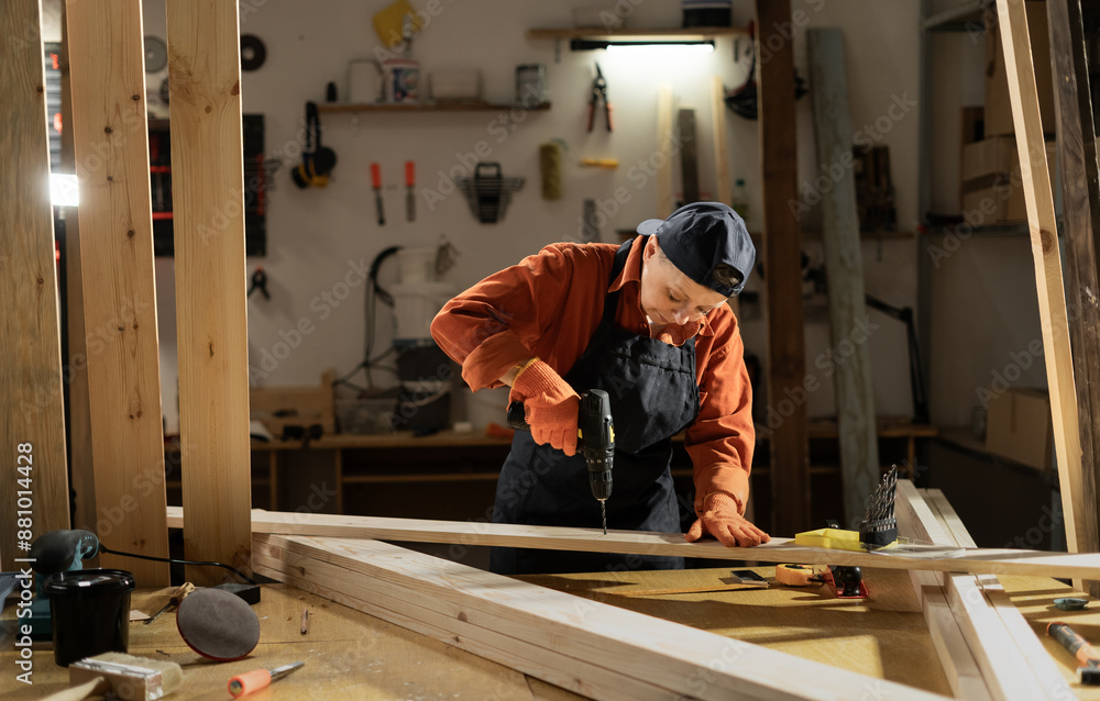 Woman Carpenter working with drill at carpentry workshop Woman Carpenter working with drill at carpentry workshop