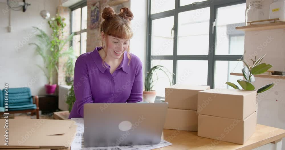 Female Entrepreneur looking at order details from E-commerce site and on Phone Female Entrepreneur looking at order details from E-commerce site and on Phone