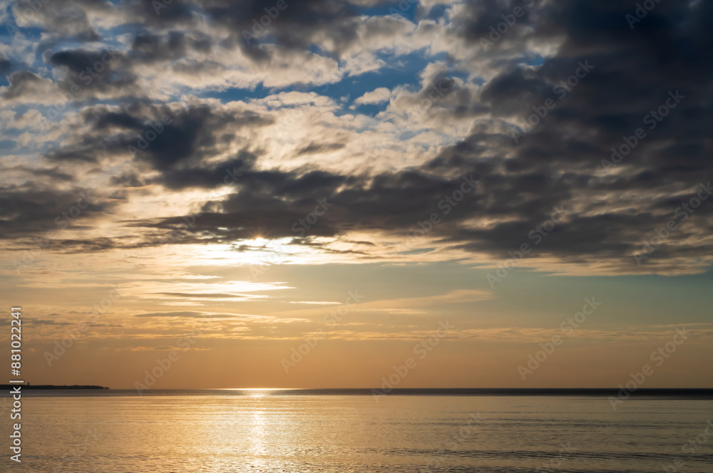 Sunset over the sea. Reflection of sunlight in the sea waves. The sky in the sunset rays. Baltic Sea. Sunset over the sea. Reflection of sunlight in the sea waves. The sky in the sunset rays. Baltic Sea.