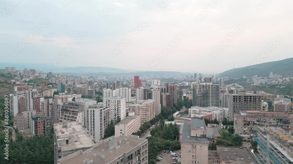 Aerial rising view construction site with crane cary block material and workers working. Real estate site in Saburtalo, Tbilisi, Georgia Aerial rising view construction site with crane cary block material and workers working. Real estate site in Saburtalo, Tbilisi, Georgia