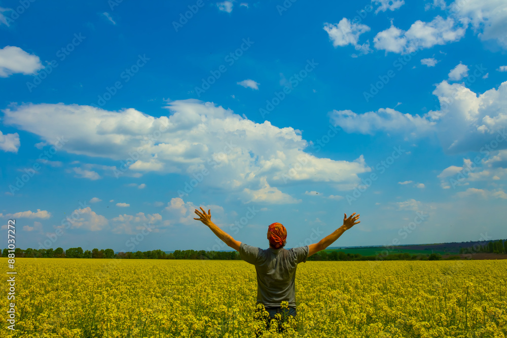 happy man stay among yellow rape field under blue cloudy sky happy man stay among yellow rape field under blue cloudy sky
