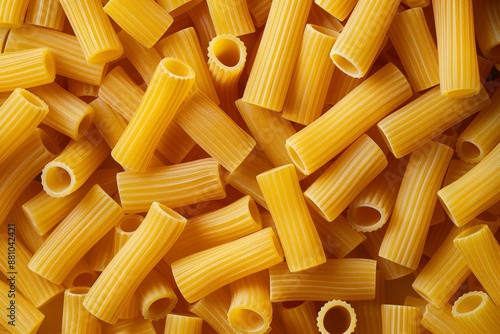 Flat lay photography of dry uncooked tortiglioni or rigatoni pasta as a textured background