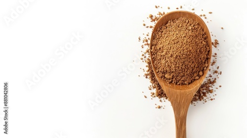 Brown flaxseed or linseed powder on wooden spoon against white background