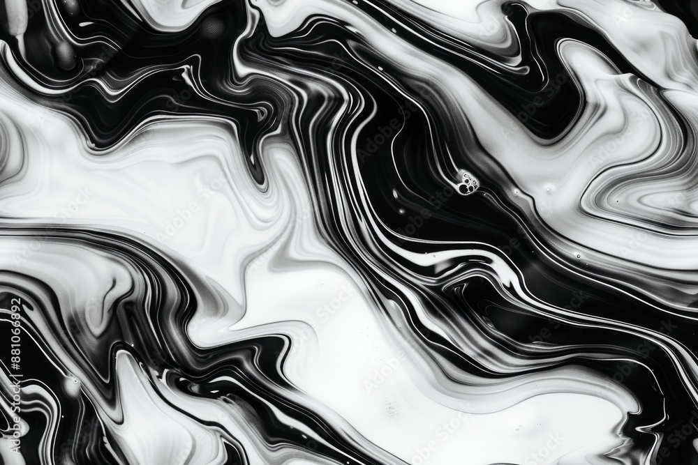 Obraz premium Abstract image with swirling black and white paint, creating a fluid and mesmerizing pattern.