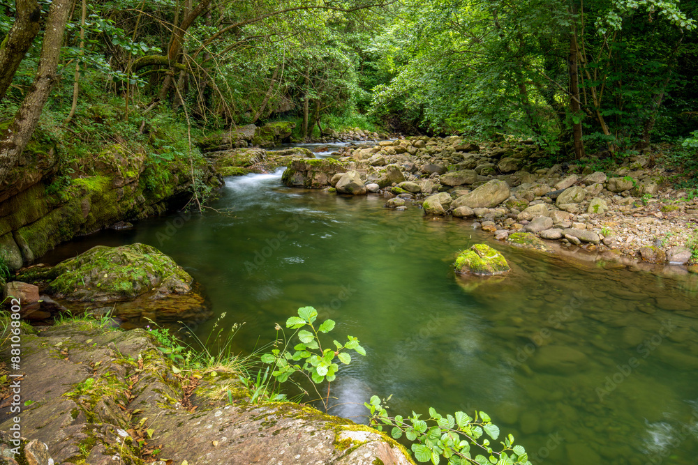 Argonza River as it passes through the medieval city of Bárcena Mayor, Cantabria, Spain, with its emerald green and calm waters Argonza River as it passes through the medieval city of Bárcena Mayor, Cantabria, Spain, with its emerald green and calm waters