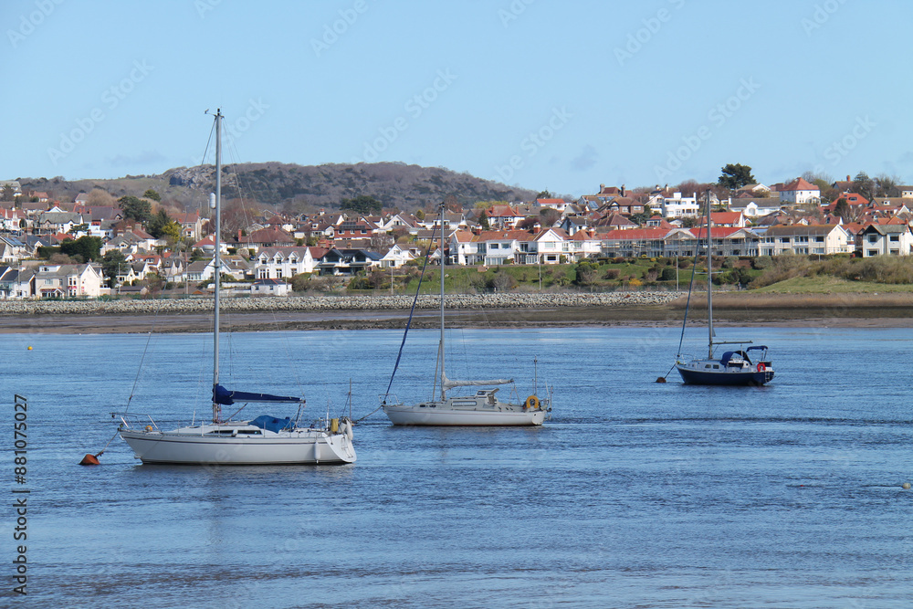 Three Sailing Boats Moored in a Quiet Seaside Harbour. Three Sailing Boats Moored in a Quiet Seaside Harbour.