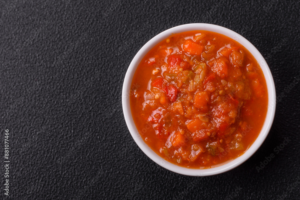 Red hot or spicy sauce with chili peppers, tomatoes, garlic, spices Red hot or spicy sauce with chili peppers, tomatoes, garlic, spices