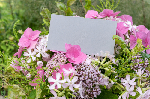 Summer bouquet with pink hydrangeas, soapwort, oregano and card with copy space