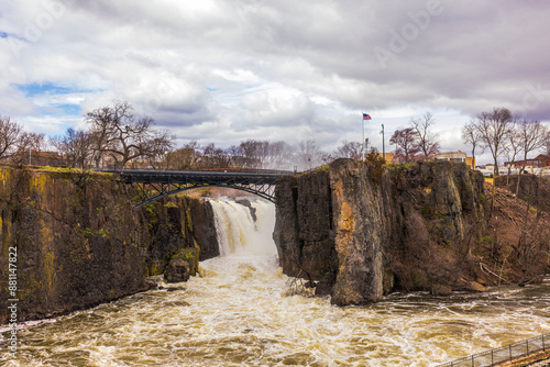 Stunning view of Paterson Falls with historic bridge, set against spring landscape, showcasing nature's beauty and serenity. New Jersey, USA. photo