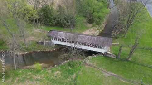 Knisely covered bridge near New Paris, PA. Extreme high angle overhead shot of the bridge and the stream underneath. Shot in early Spring. photo