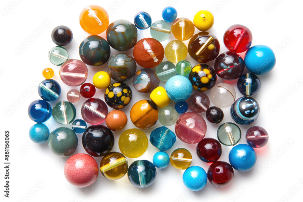 A bunch of colorful glass beads are scattered on a white background A bunch of colorful glass beads are scattered on a white background