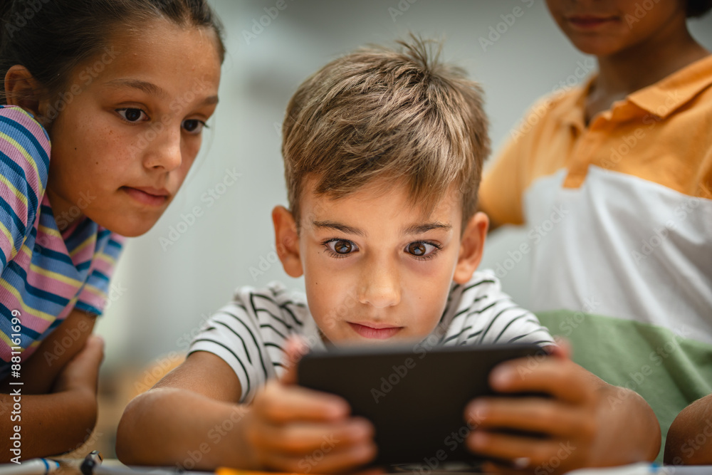 Young students use cellphone for video games on a break at school Young students use cellphone for video games on a break at school