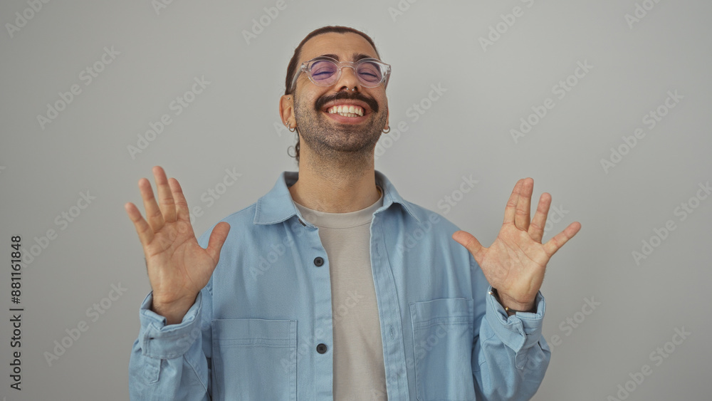 Young hispanic man with moustache smiling and gesturing in excitement against an isolated white background Young hispanic man with moustache smiling and gesturing in excitement against an isolated white background
