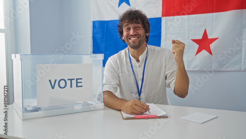Young man voting in an election with the panamanian flag in the background, showing success and happiness.