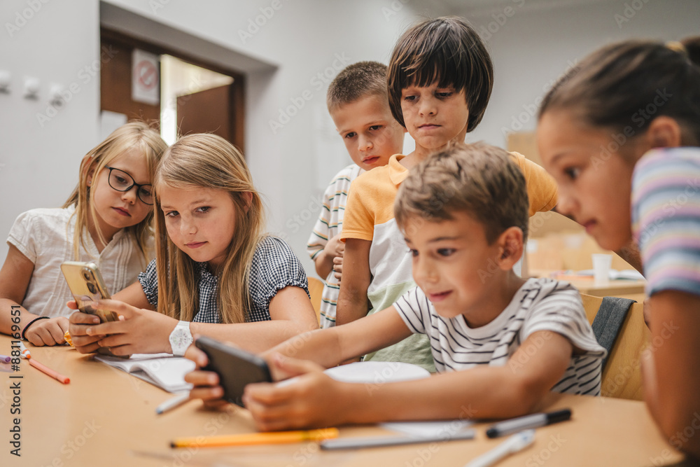 Young students use cellphone for video games on a break at school Young students use cellphone for video games on a break at school