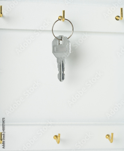 The key to the door hangs in the hallway. Door key.