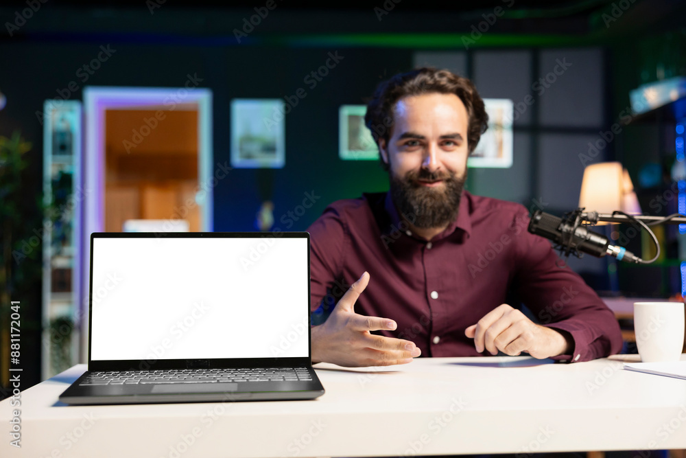 Smiling influencer talking to audience about recent news headlines, reading from mockup laptop. Cheerful man discussing with subscribers, presenting information from isolated screen notebook Smiling influencer talking to audience about recent news headlines, reading from mockup laptop. Cheerful man discussing with subscribers, presenting information from isolated screen notebook