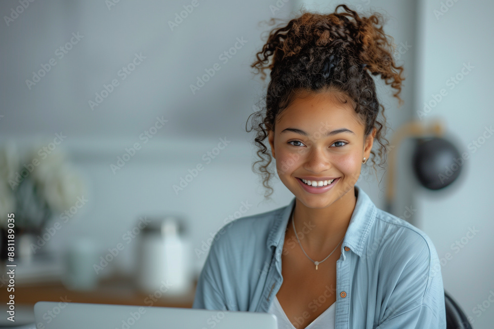 a smiling young professional sits in the office a smiling young professional sits in the office