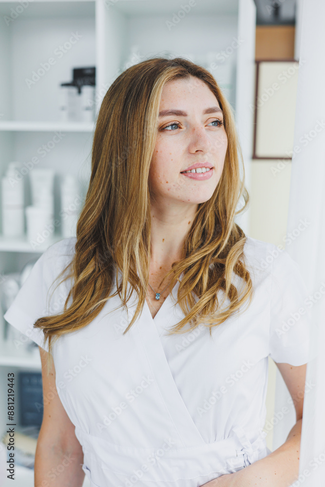 Portrait of a young female doctor in a white surgical suit. Clothes for a doctor.