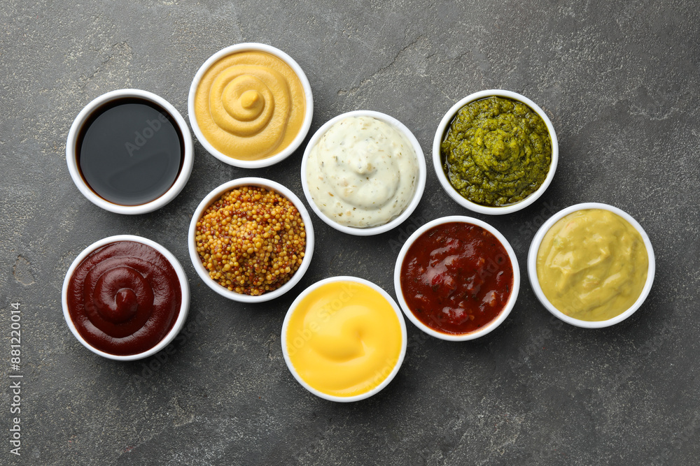 Many different sauces in bowls on grey table, top view Many different sauces in bowls on grey table, top view