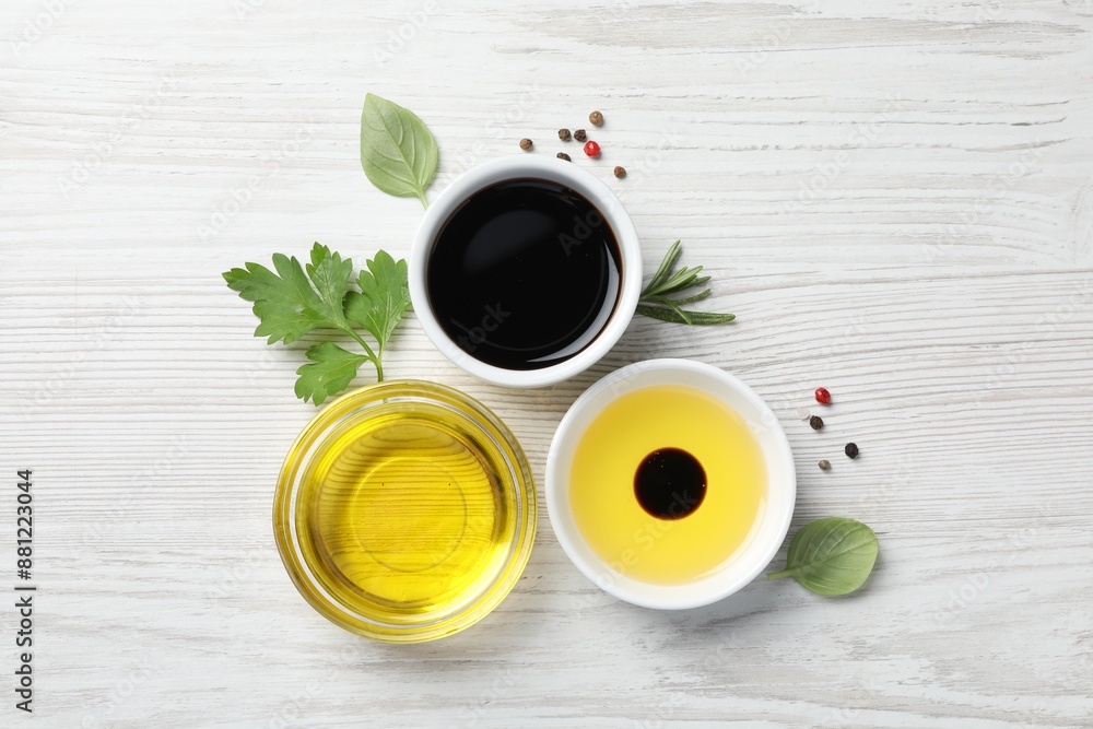Balsamic vinegar, oil and other products on white wooden table, flat lay Balsamic vinegar, oil and other products on white wooden table, flat lay