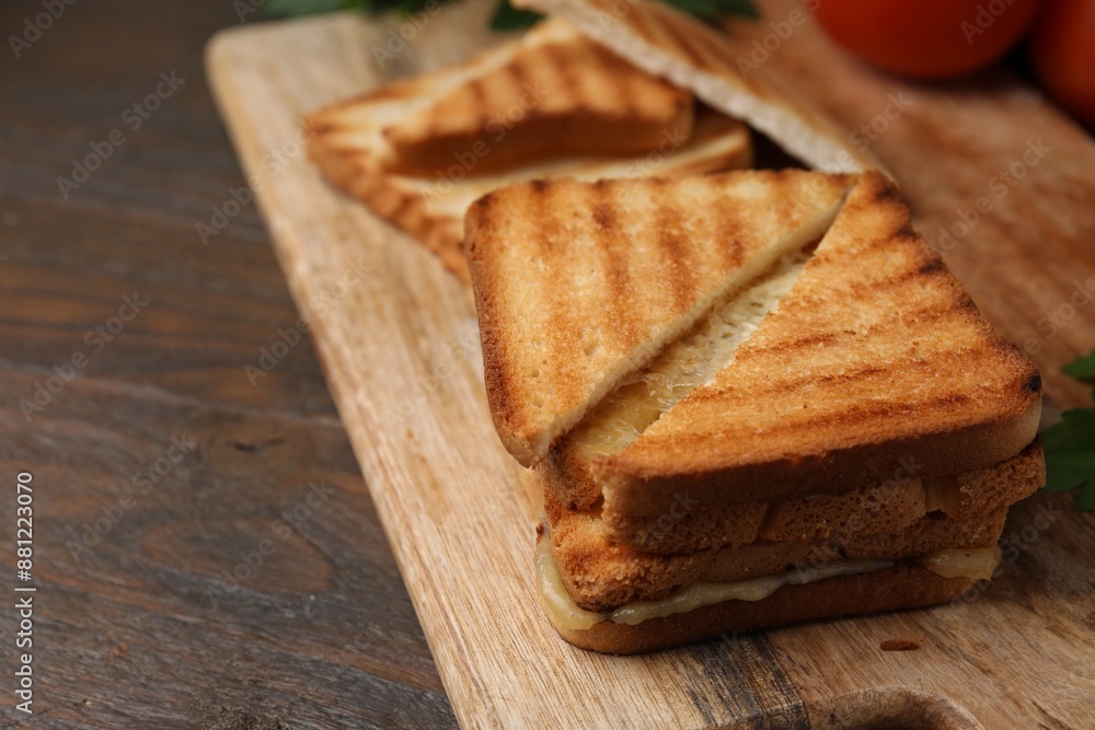 Pieces of toasted bread with melted cheese on wooden table, closeup Pieces of toasted bread with melted cheese on wooden table, closeup