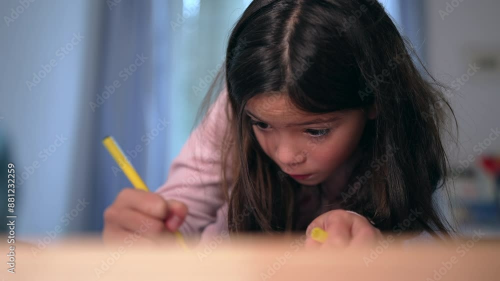 Little girl focused on drawing on paper with yellow coloring pen in bedroom. Child engaged in creative artistic leisure time, childhood development Little girl focused on drawing on paper with yellow coloring pen in bedroom. Child engaged in creative artistic leisure time, childhood development