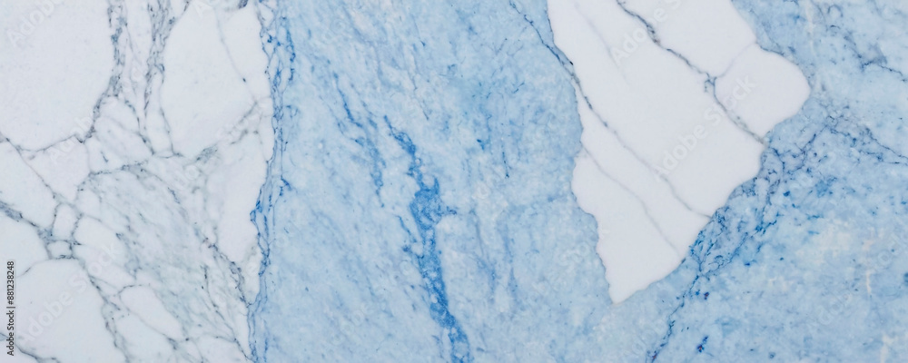 A close-up shot of a marble surface with a striking contrast between a deep blue section and a white section. The blue area features intricate patterns of swirls and veins. A close-up shot of a marble surface with a striking contrast between a deep blue section and a white section. The blue area features intricate patterns of swirls and veins.