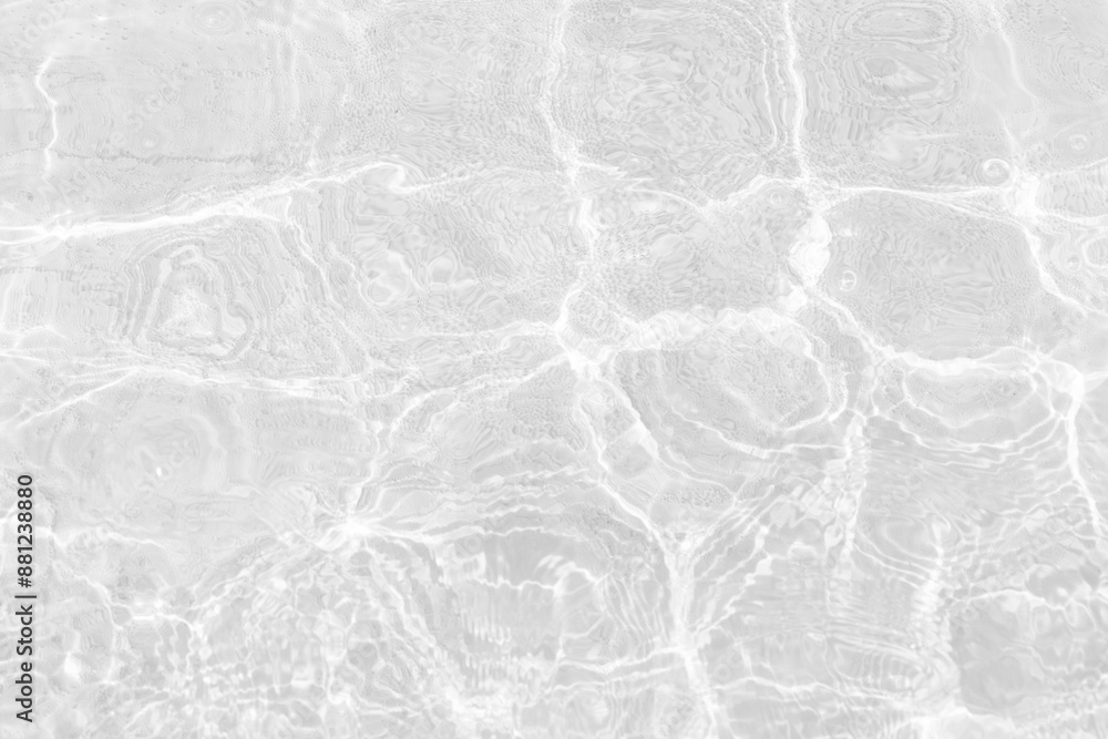 Naklejka premium White water with ripples on the surface. Defocus blurred transparent white colored clear calm water surface texture with splashes and bubbles. Water waves with shining pattern texture background.