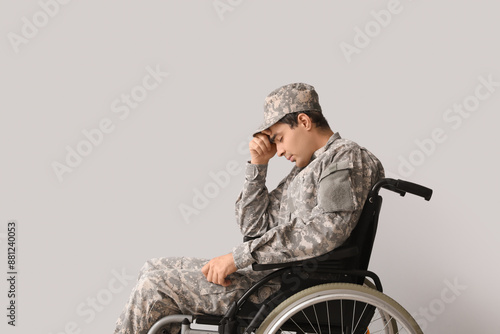 Sad young soldier in wheelc...